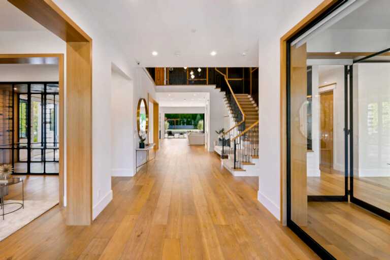 Modern house entryway with hardwood floors and contemporary staircase